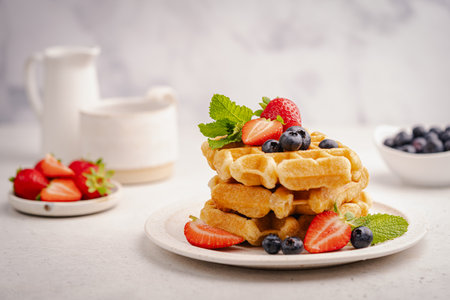 Tasty Belgian waffles with fresh berriesの写真素材