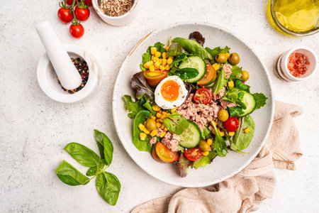 Tuna salad with tomatoes , olives , eggs and onion .の写真素材