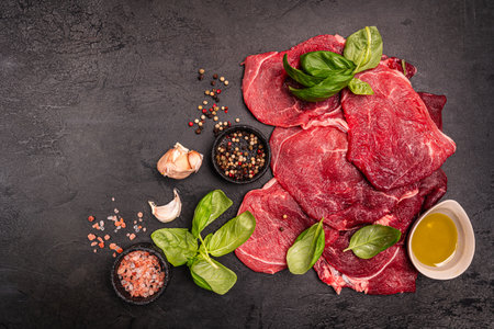 Raw organic steak with ingredients for cookingの写真素材