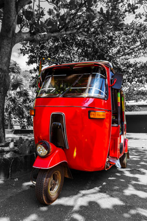 Bright red auto rickshaw