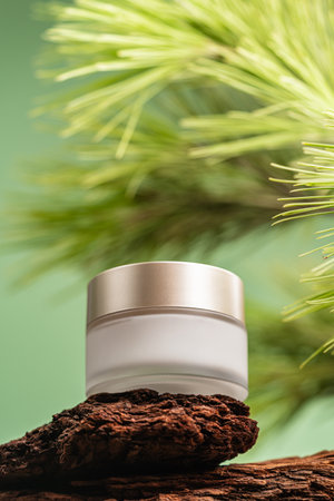 Age cream on pine bark with green background, natural skincare conceptの写真素材
