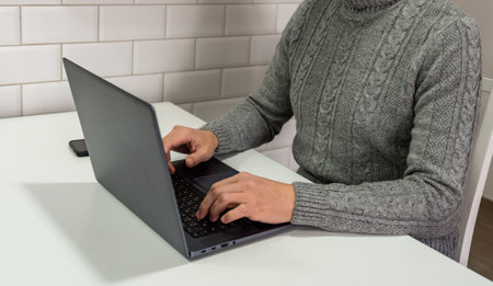 Middle aged man looking at laptop