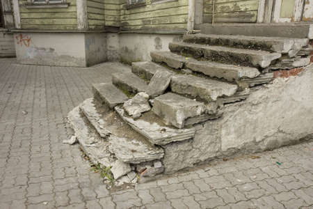 Old ruined and dirty staircase near an abandoned houseの写真素材