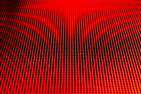 Red dot lights arranged on a video screen matrix. Shallow depth of field for a blurred effect.の写真素材