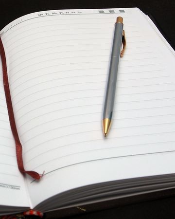 gold pen on the bookの写真素材