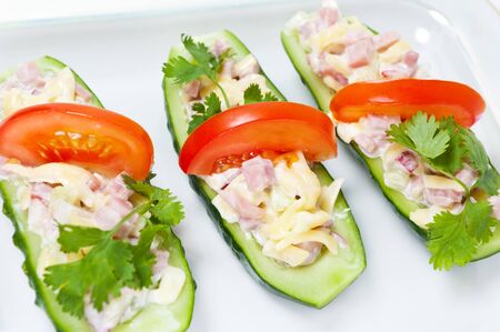 Cucumbers stuffed with ham, cheese and radishの写真素材
