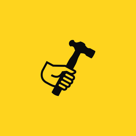 Human hand holding Hammer icon. Hammer vector icon on a yellow background. Hammer iconのイラスト素材