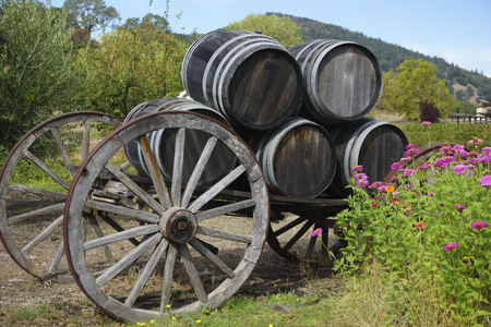 wine barrels on wagon with flowersの写真素材
