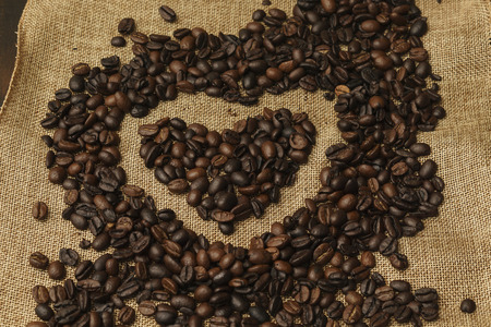 heart made of coffee beans on burlapの写真素材