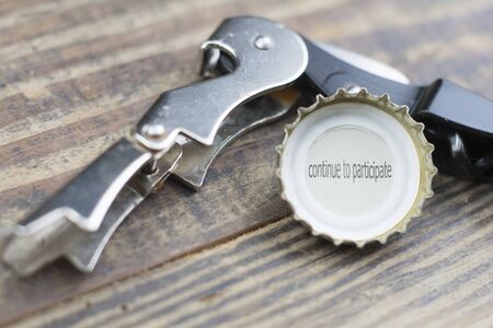 beer cap with the legend says That continue to Participateの写真素材