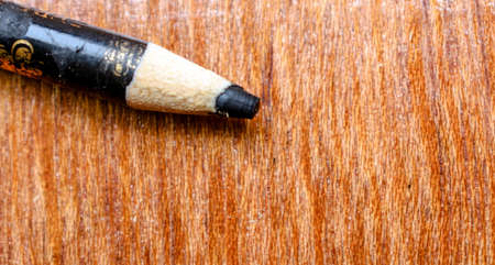 Black eyeliner pencil, known as `Kajal` in India, sharpened and put on the wooden dressing table. closeup photography.の写真素材