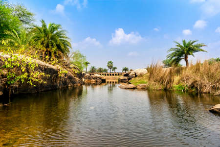 urban Indian river surrounded by stones and rocksの写真素材