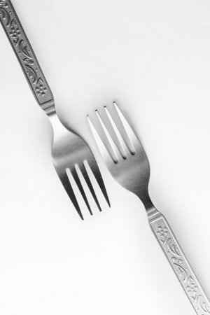 Vintage engraving silverware fork set of two placed one against another isolated on white backgroundの写真素材