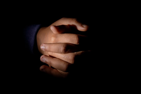 Hand close-up on black backdrop. studio capture with ample copy space.の写真素材