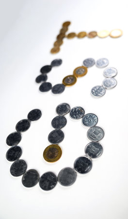 Depiction of monetary coins arranged to form the acronym 'GST,' symbolizing the financial and taxation concept related to the Goods and Services Tax policy.の写真素材