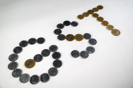 Depiction of monetary coins arranged to form the acronym 'GST,' symbolizing the financial and...