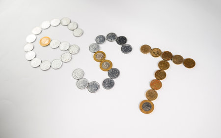Depiction of monetary coins arranged to form the acronym 'GST,' symbolizing the financial and taxation concept related to the Goods and Services Tax policy.の写真素材
