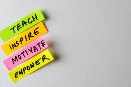 Four colorful sticky notes display motivational words like Teach, Inspire, Motivate and Empower,...