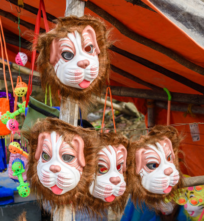 A collection of vibrant animal-themed masks displayed at a festival stall, showcasing playful designs and creative artistry.の写真素材