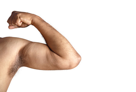 A close-up image showcasing a flexed bicep on a white background, symbolizing power and showcasing physical fitness.の写真素材