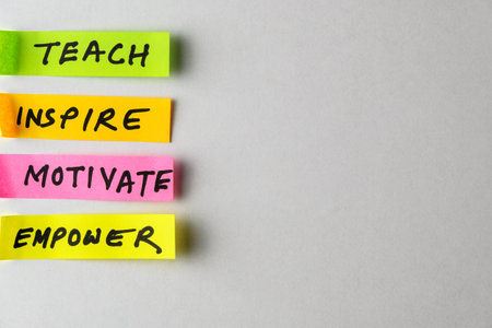 Bright multicolored sticky notes featuring inspiring terms like Teach, Inspire, Motivate, and...