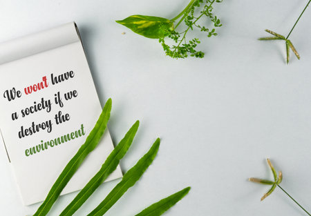Inspirational note about environmental preservation paired with green leaves, symbolizing nature and...