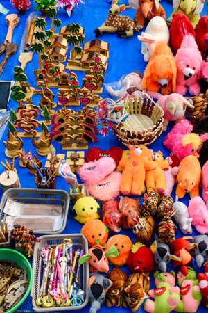 A lively arrangement of stuffed plush toys, wooden crafts, and various handmade souvenirs at a market, showcasing the vibrant creativity and craftsmanship of local artisans.の写真素材