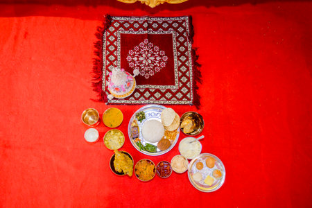 Authentic Indian dishes served on a decorative tray showcasing rich culture and flavors, complemented with traditional accompaniments on a festive background.の写真素材