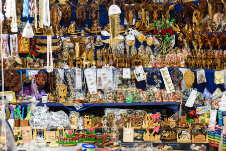 Colorful collection of handcrafted wooden artistic items on display at a vibrant traditional market, showcasing varied sculptures, intricate designs, and unique handicrafts perfect for home decor and gifting.の写真素材