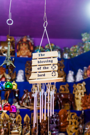 A vibrant display of handcrafted wooden plaques and vivid chimes, beautifully arranged in a traditional artisan shop. The combination emphasizes creativity, positivity, and cultural craftsmanship.の写真素材