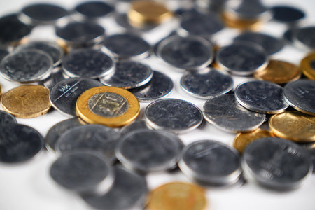 Various golden and silver coins grouped together, showcasing shiny metallic texture and value. A perfect representation for finance, economy, savings, or currency-related concepts.の写真素材