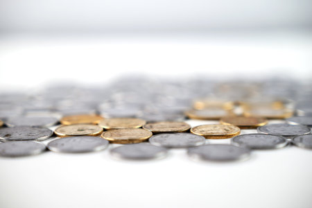 Various golden and silver coins grouped together, showcasing shiny metallic texture and value. A perfect representation for finance, economy, savings, or currency-related concepts.の写真素材