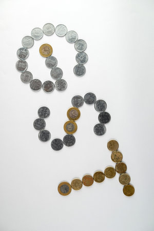 Depiction of monetary coins arranged to form the acronym 'GST,' symbolizing the financial and taxation concept related to the Goods and Services Tax policy.の写真素材
