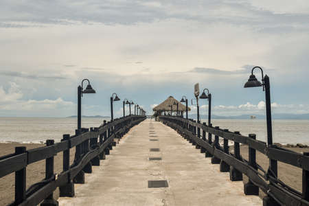 Pier on the beach, with straw Pubの写真素材