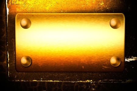 gold rusty scratched board on the old wall with empty space for text and designの写真素材