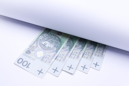 polish money: zloty, banknotes under roll of paper for text or designの写真素材