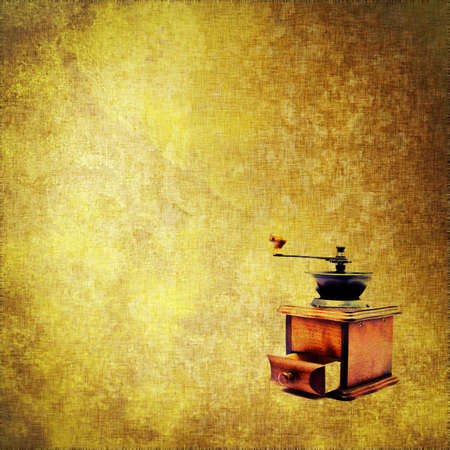 Vintage wooden coffee mill grinder on grungy textile backgroundの写真素材