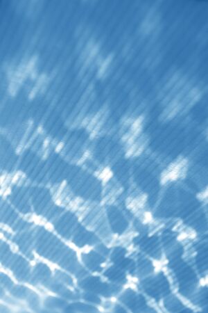blue wall texture background with white light reflections and delicate light rays, may use as abstract book coverの写真素材