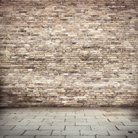 grunge background, red brick wall texture bright plaster wall and blocks road sidewalk abandoned exterior urban background for your concept or projectの写真素材