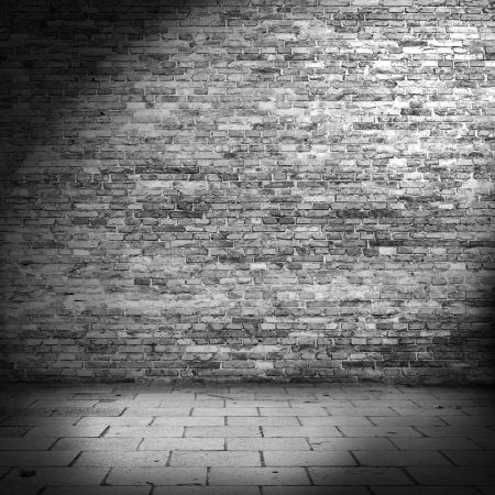 dark brick wall background in basement with beam of lightの写真素材