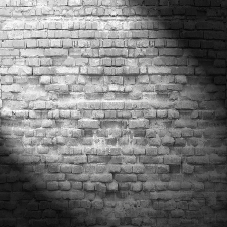 black and white interior brick wall texture background and beam of spot lightの写真素材