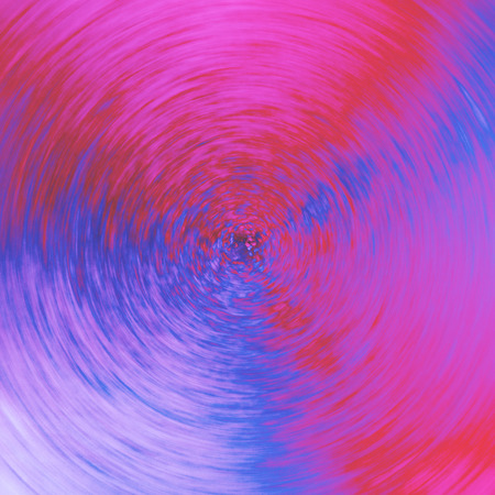 garish pink blue red abstract background concentric swirl textureの写真素材