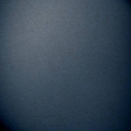 dark blue abstract background smooth suede paper surface subtle vignetteの写真素材
