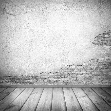 interior background, old plastered wall texture and wooden planks tiled floor in black and whiteの写真素材