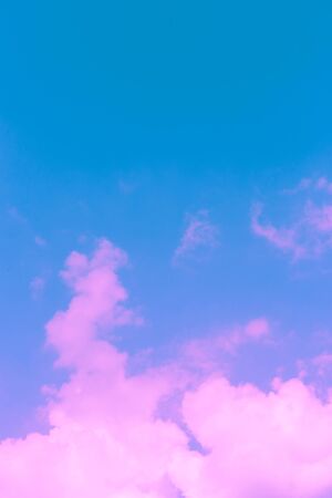 pink abstract puffy clouds on blue backgroundの写真素材