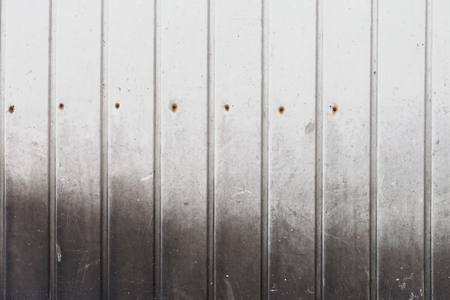 old wall white painted corrugated sheet of metal tinware grunge backgroundの写真素材