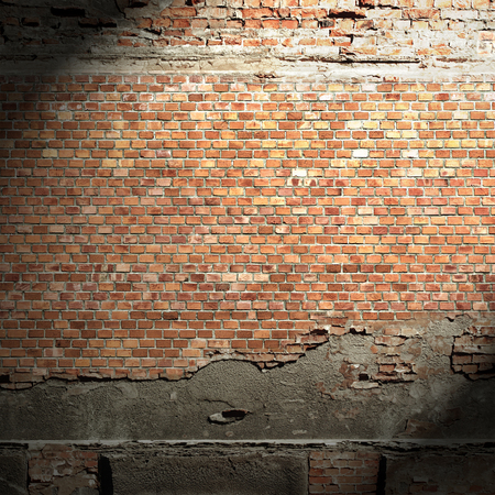 urban background grunge brick wall texture, beam of light and shadow vignetteの写真素材
