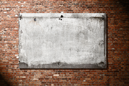 gray concrete billboard on red brick wall texture background and shadow vignetteの写真素材