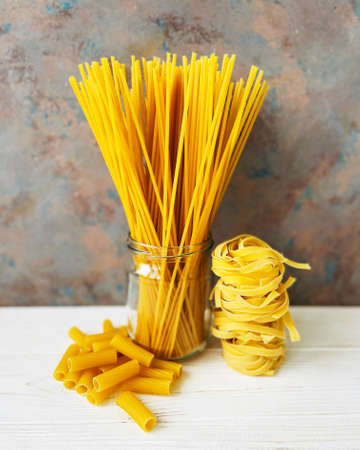 different types of pasta on a wooden table