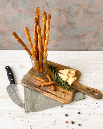 grissini with herbs and cheese, on a wooden table